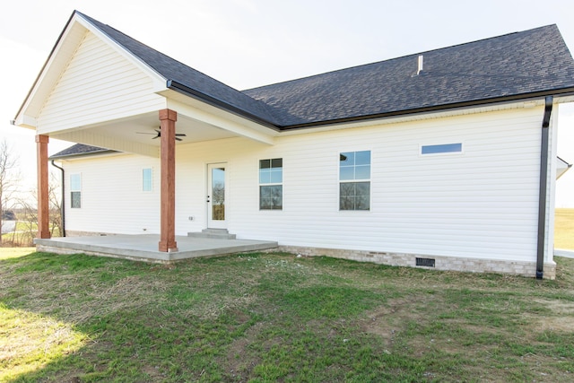 back of property featuring ceiling fan, a patio area, and a lawn