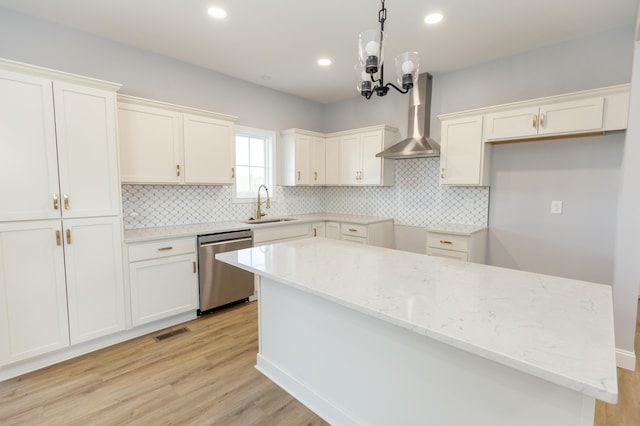 kitchen with dishwasher, white cabinets, and wall chimney exhaust hood