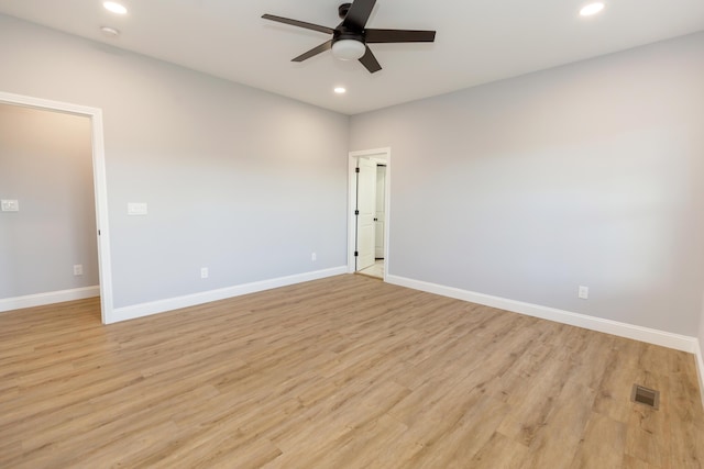 empty room with ceiling fan and light hardwood / wood-style floors