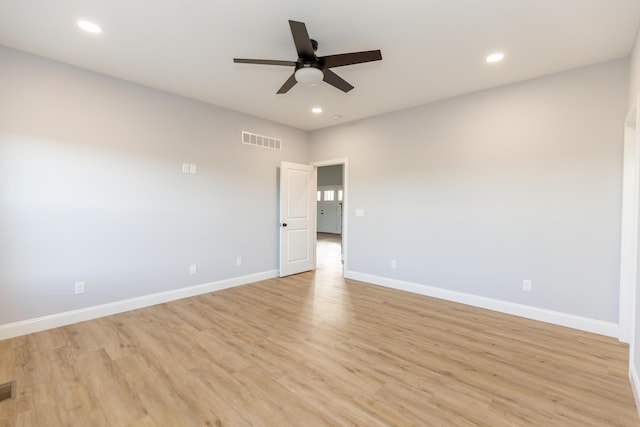 empty room with ceiling fan and light hardwood / wood-style flooring