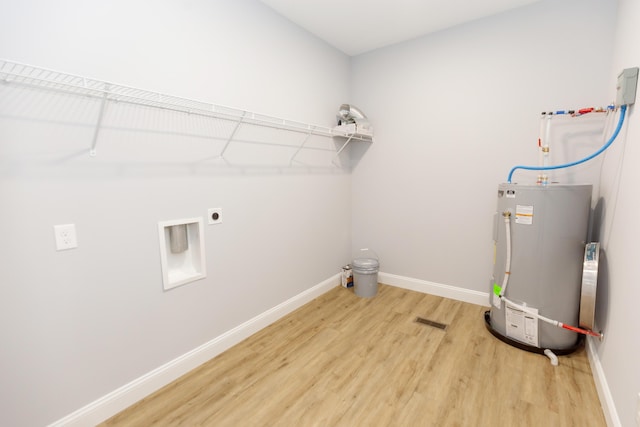 laundry room featuring gas water heater, hookup for an electric dryer, and wood-type flooring