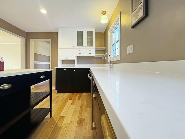 kitchen featuring light hardwood / wood-style flooring and white cabinetry