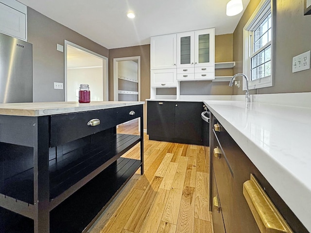 kitchen with white cabinets and light hardwood / wood-style flooring