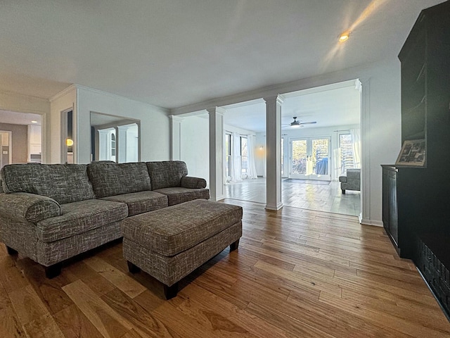 living room with hardwood / wood-style floors and ornate columns