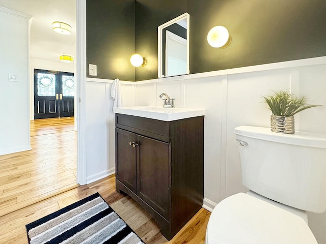 bathroom featuring hardwood / wood-style floors, vanity, and toilet