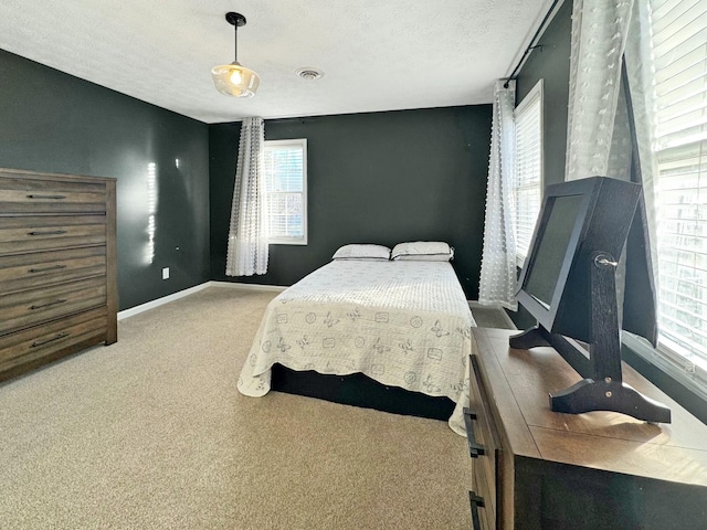 carpeted bedroom featuring a textured ceiling