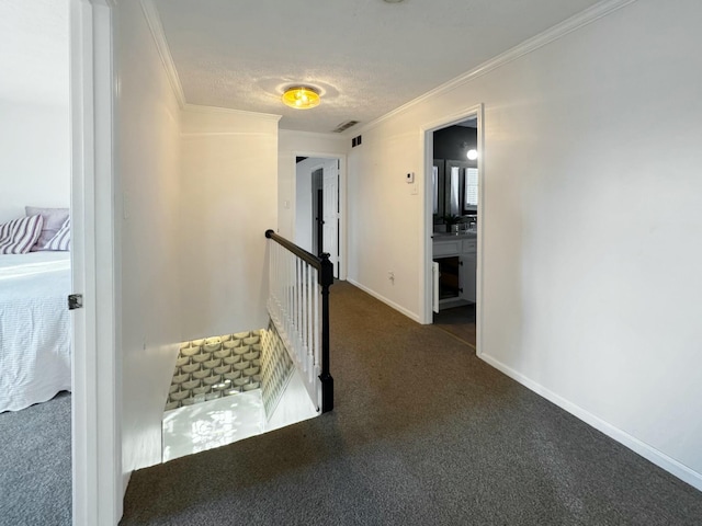 hall featuring dark colored carpet and crown molding