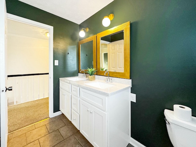 bathroom featuring toilet and vanity