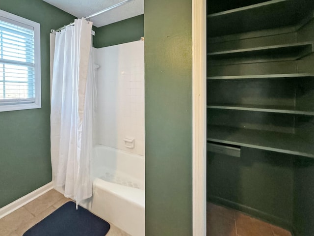 bathroom featuring shower / bathtub combination with curtain and tile patterned floors