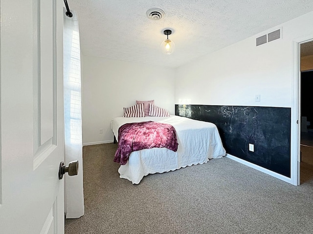 carpeted bedroom featuring a textured ceiling