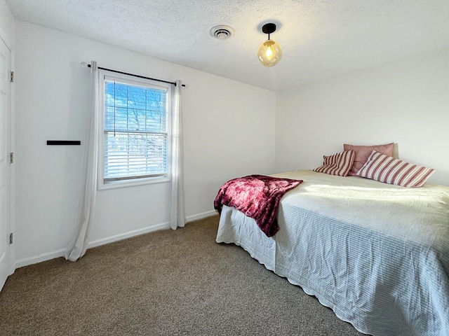 carpeted bedroom featuring a textured ceiling