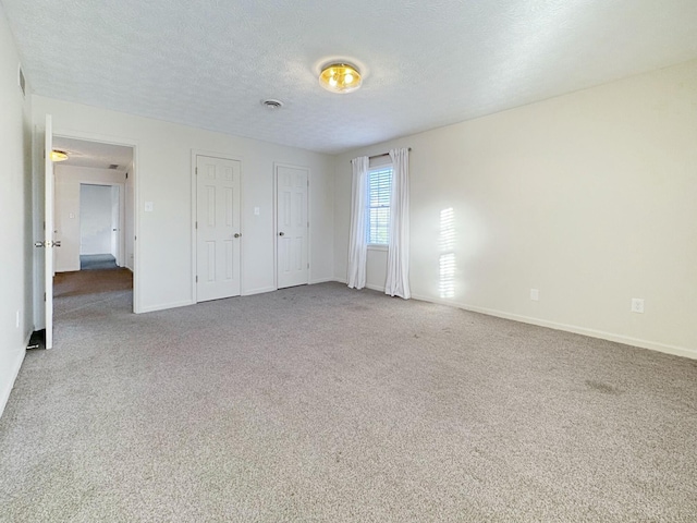 unfurnished bedroom with carpet floors and a textured ceiling