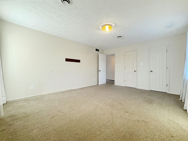 unfurnished bedroom featuring carpet and a textured ceiling