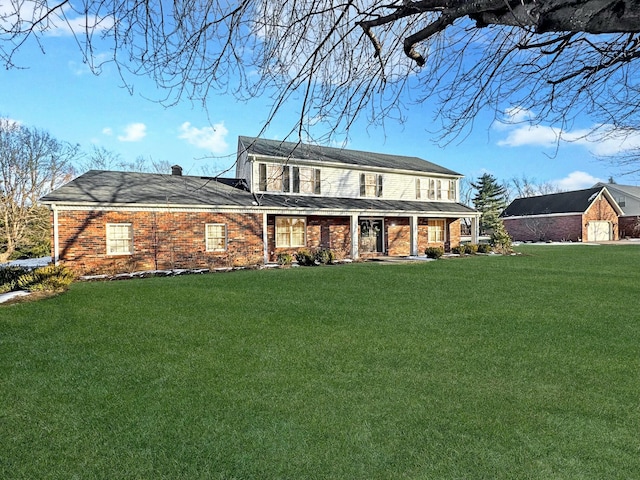 rear view of house featuring a yard and a porch