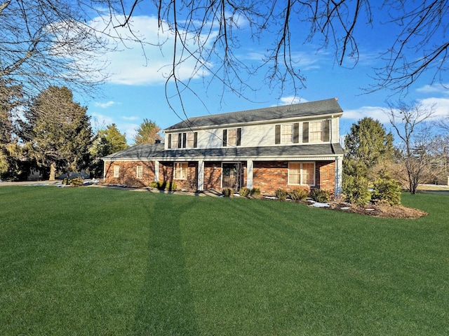 back of house featuring a yard and a porch