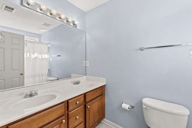 bathroom with vanity, toilet, and curtained shower