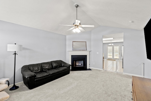 living room featuring lofted ceiling, ceiling fan, and carpet flooring