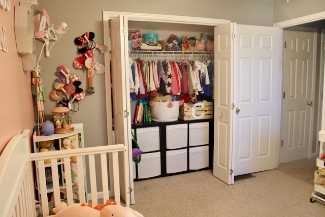 bedroom featuring a closet and light carpet