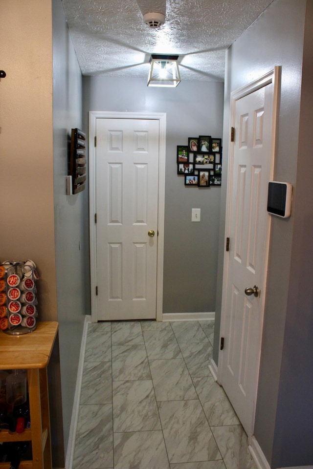 doorway featuring a textured ceiling