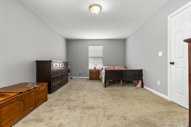bedroom with baseboards and light carpet