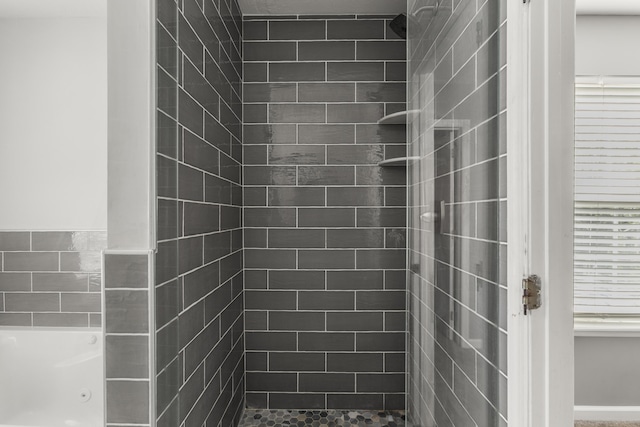 full bath featuring a jetted tub and a stall shower