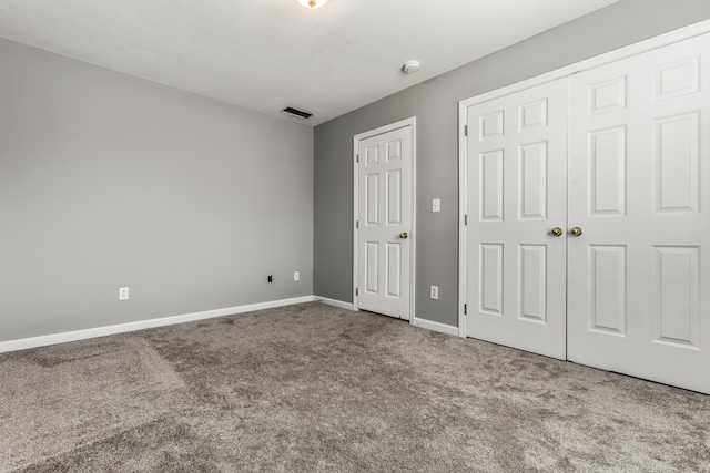 unfurnished bedroom with carpet flooring and baseboards