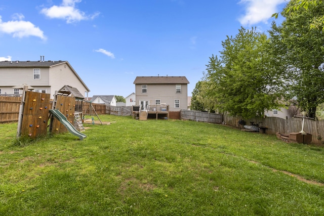 view of yard with a playground and a fenced backyard