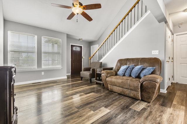 living area with stairs, ceiling fan, visible vents, and dark wood-style floors