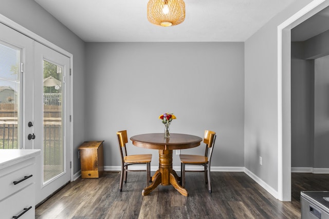 dining room featuring baseboards and dark wood-type flooring