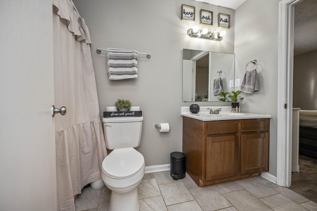 bathroom featuring vanity, tile patterned floors, and toilet