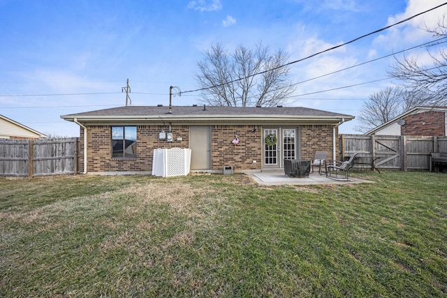 rear view of house featuring a yard and a patio