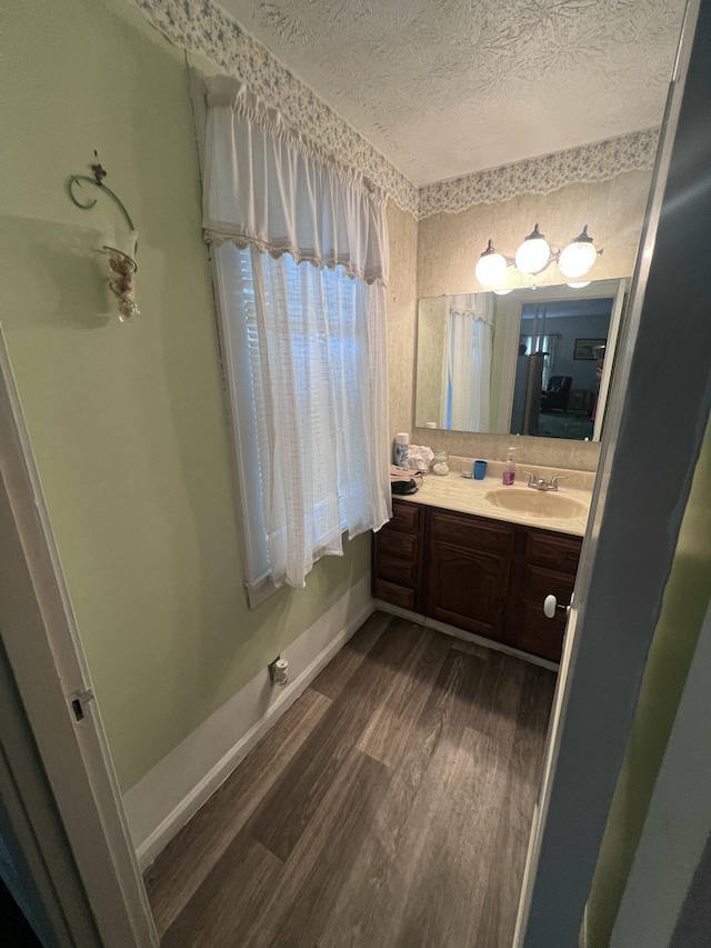 bathroom featuring wood-type flooring, a textured ceiling, and vanity