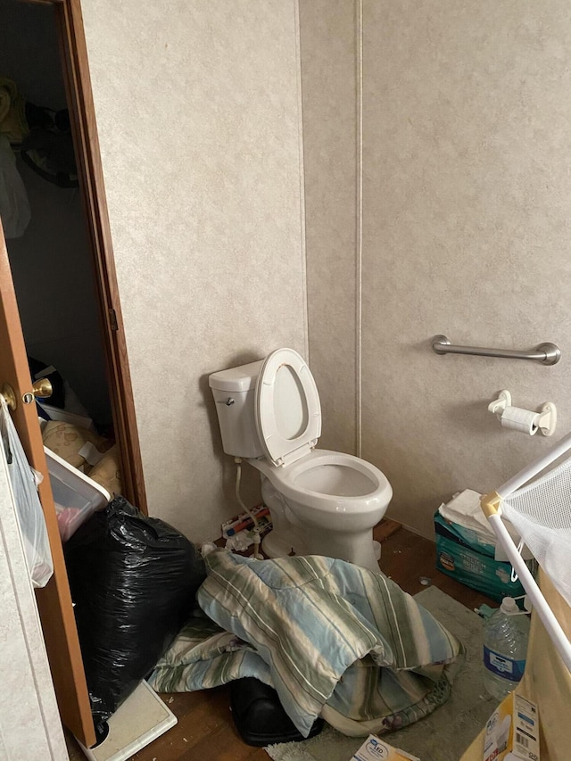 bathroom featuring hardwood / wood-style floors and toilet