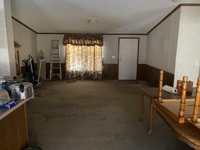 misc room with ornamental molding and a textured ceiling