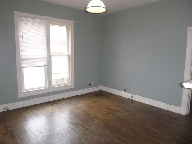 spare room featuring dark hardwood / wood-style flooring