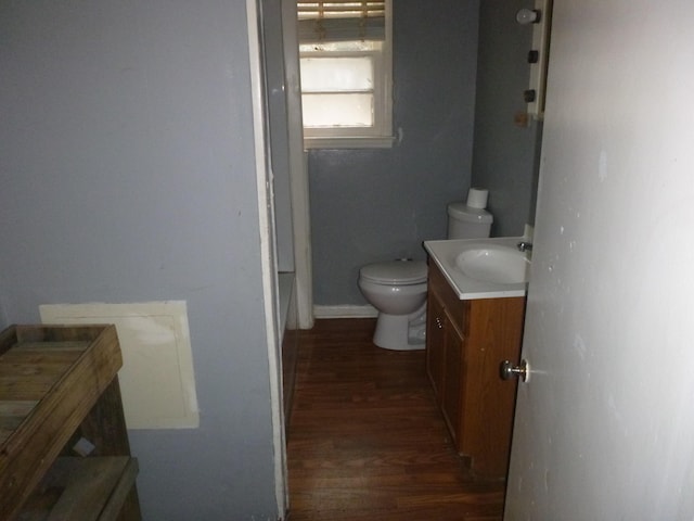 bathroom with hardwood / wood-style flooring, vanity, and toilet