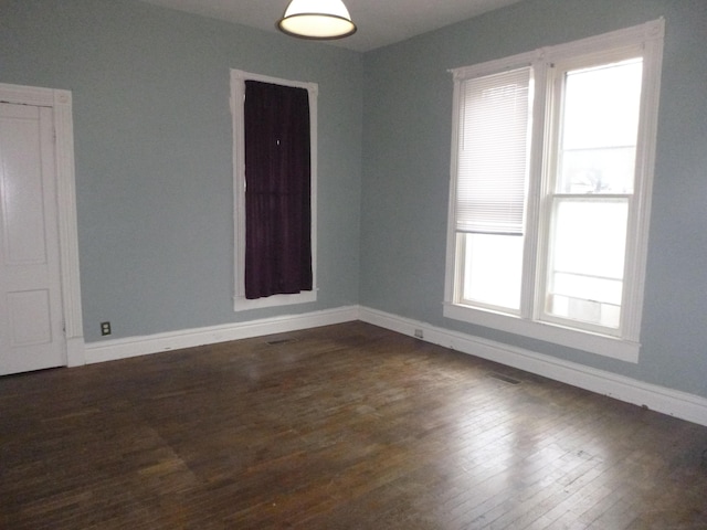 unfurnished room with dark hardwood / wood-style flooring