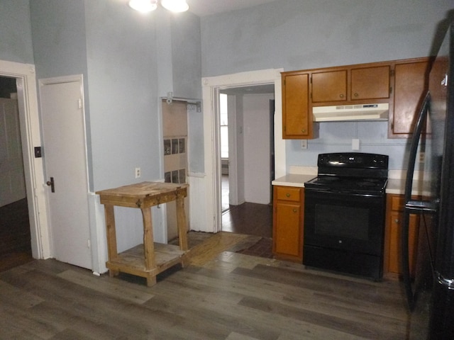 kitchen featuring dark hardwood / wood-style flooring and black appliances