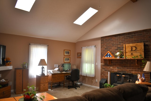 office featuring a fireplace, a skylight, high vaulted ceiling, and light carpet