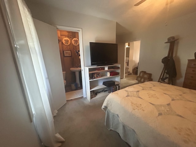 carpeted bedroom with sink and connected bathroom