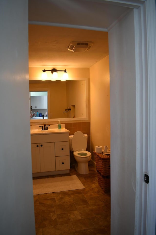 bathroom featuring vanity and toilet