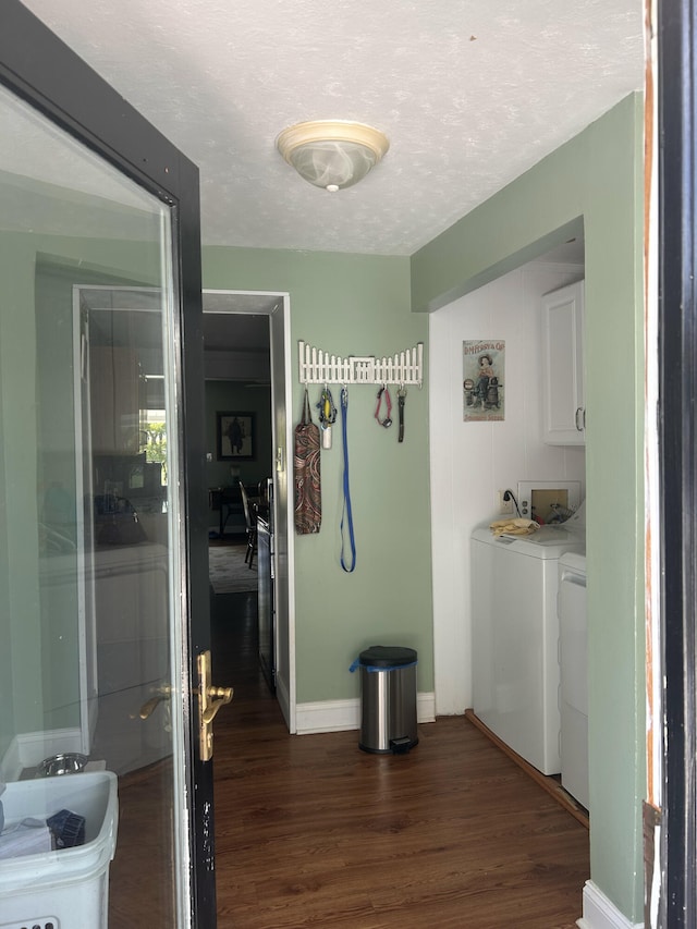 corridor with dark hardwood / wood-style floors, washer and dryer, and a textured ceiling