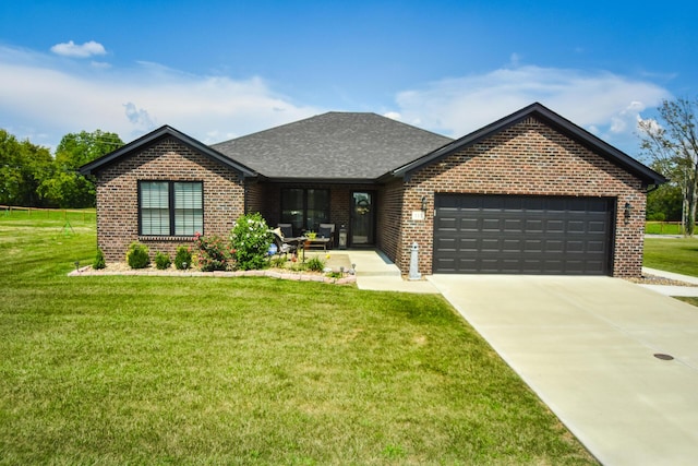 view of front of house with a garage and a front lawn