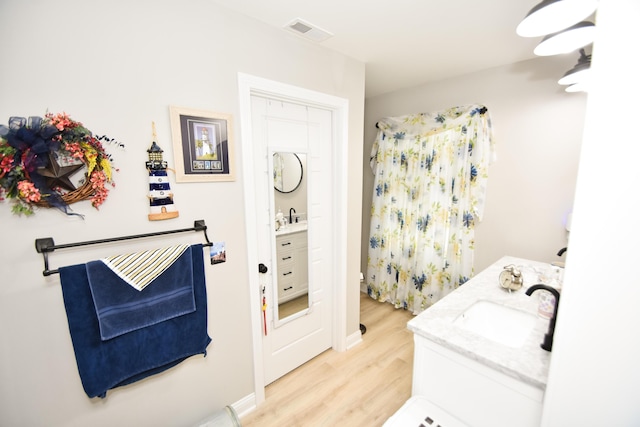 laundry area with sink and light wood-type flooring