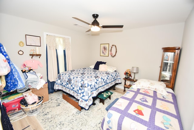 bedroom featuring hardwood / wood-style flooring and ceiling fan