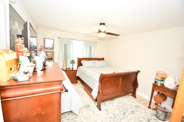 bedroom with ceiling fan and light hardwood / wood-style flooring