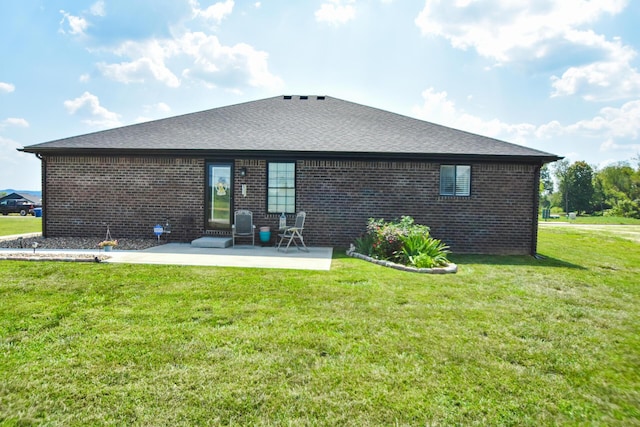 back of house with a yard and a patio area