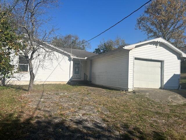 view of side of home with a garage and a yard