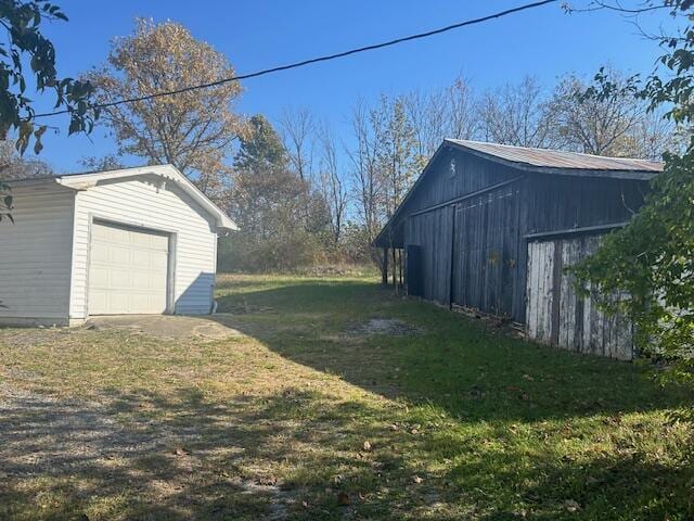 exterior space featuring a garage and an outdoor structure