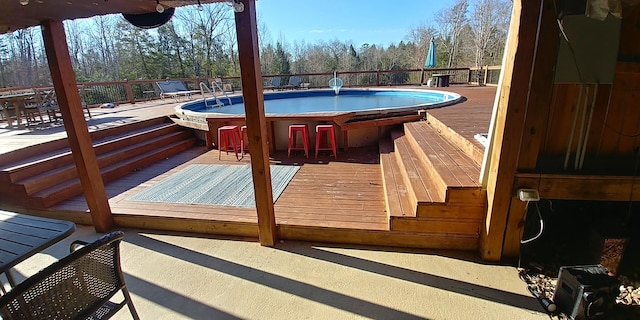 view of swimming pool featuring a jacuzzi and a deck